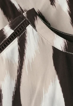 Blouse à épaules tombantes avec bandes décoratifves