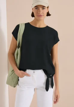 Blouse avec col rond et détail de nœuds