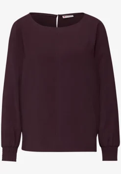 Blouse avec poignets smockés